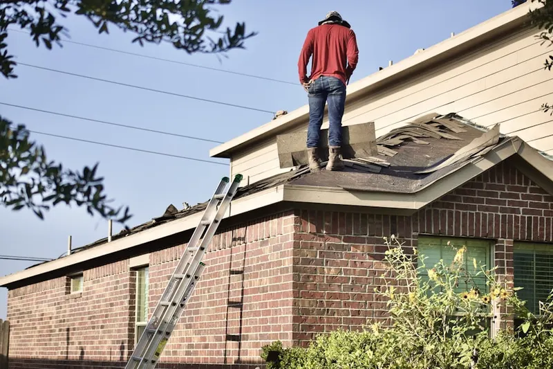 Professional roofer working on a residential roof in Delaware